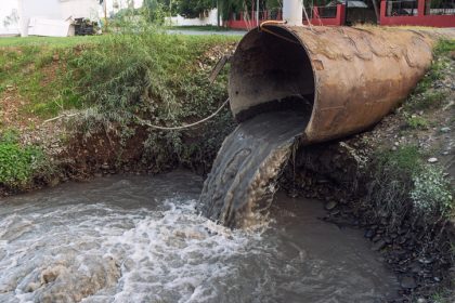 Dirty water from stormwater drains empties into river.