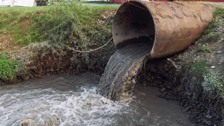 Dirty water from stormwater drains empties into river.