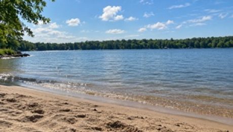 Lakefront property with a sandy beach.