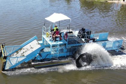 Like an underwater lawnmower, an aquatic weed harvester cuts the vegetation, collecting and storing the weeds on board.